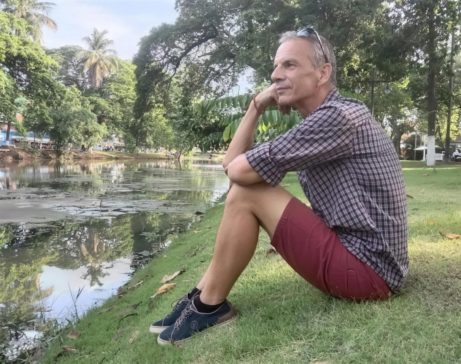 Otto F. Gatternigg sitting thoughtfully by a pond